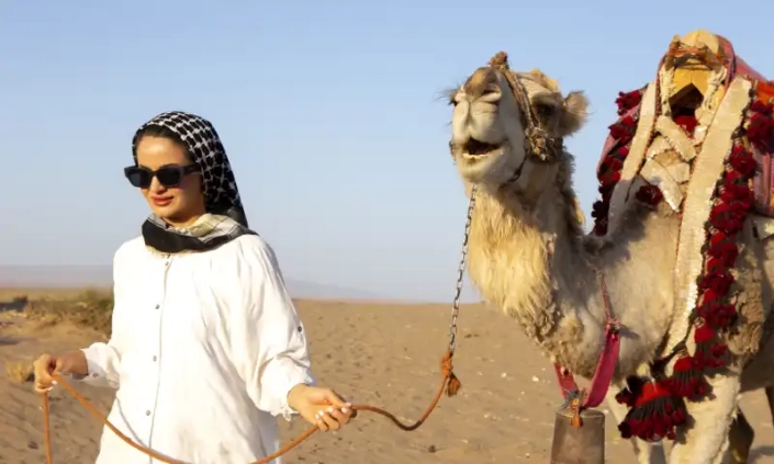 waman and smiling camel